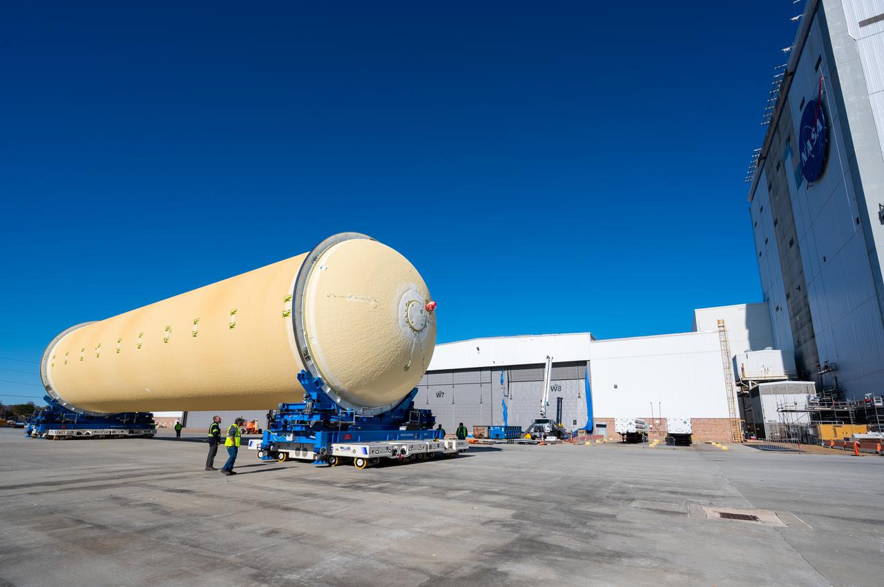 Technicians transported the assembled upper part of the Artemis II core stage to the final assembly area inside the factory at NASA’s Michoud Assembly Facility in New Orleans. On Jan 10, the forward assembly, left was moved next to the Artemis II liquid hydrogen tank, which has been undergoing assembly. Next, Boeing, the lead core stage contractor, will join the forward assembly and the liquid hydrogen tank to complete most of the core stage for the Space Launch System (SLS) rocket that will send the first crew on an Artemis mission. The core stage consists of five major structures that are built, outfitted, and then connected to form the final stage. The forward skirt, liquid oxygen and intertank were connected and tested to form the 66-foot forward assembly. After the forward assembly is joined with the 130-foot liquid hydrogen tank, only the engine section, the fifth piece of the stage, will need to be added to complete the Artemis II core stage. The core stage serves as the backbone of the rocket, supporting the weight of the payload, upper stage, and crew vehicle, as well as the thrust of its four RS-25 engines and two five-segment solid rocket boosters attached to the engine and intertank sections. On Artemis II, the SLS rocket will launch the Orion spacecraft and a crew, sending them into lunar orbit, in preparation for later Artemis missions that will enable the first woman and first person of color to land on the Moon.